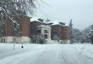 Driveway and building covered in snow 