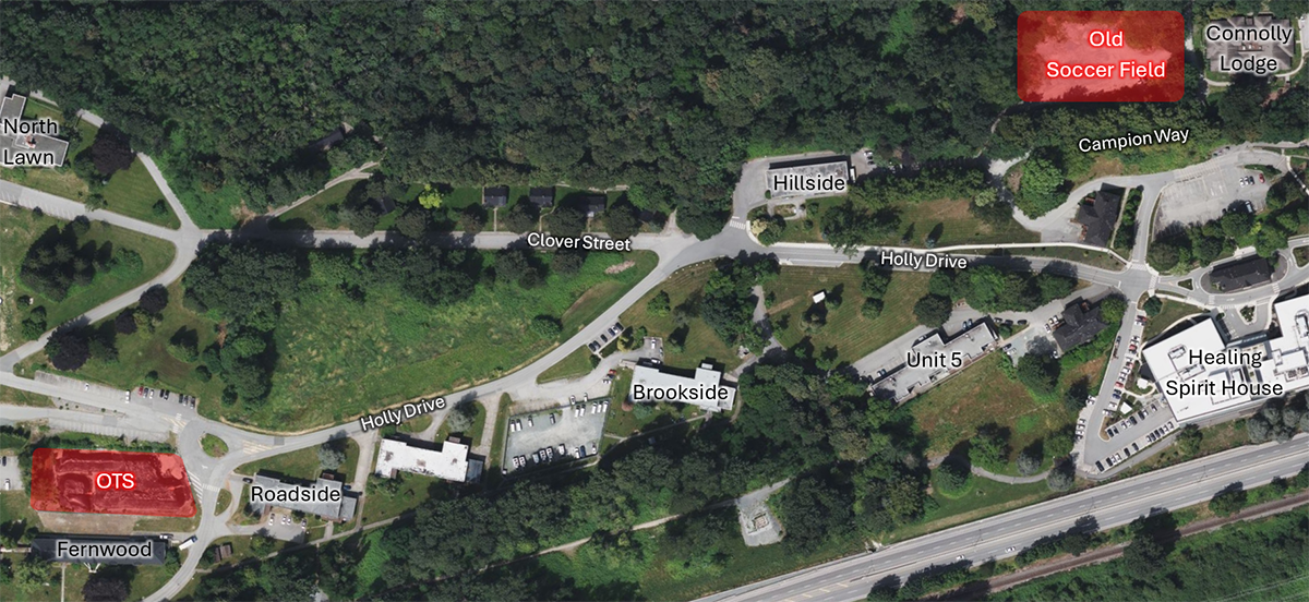 An aerial view of an area showing a storage location labeled 'Storage Location (Old Transportation Station)' situated between Holly Drive and Clover Street, with nearby buildings, parking lots, and surrounding greenery.